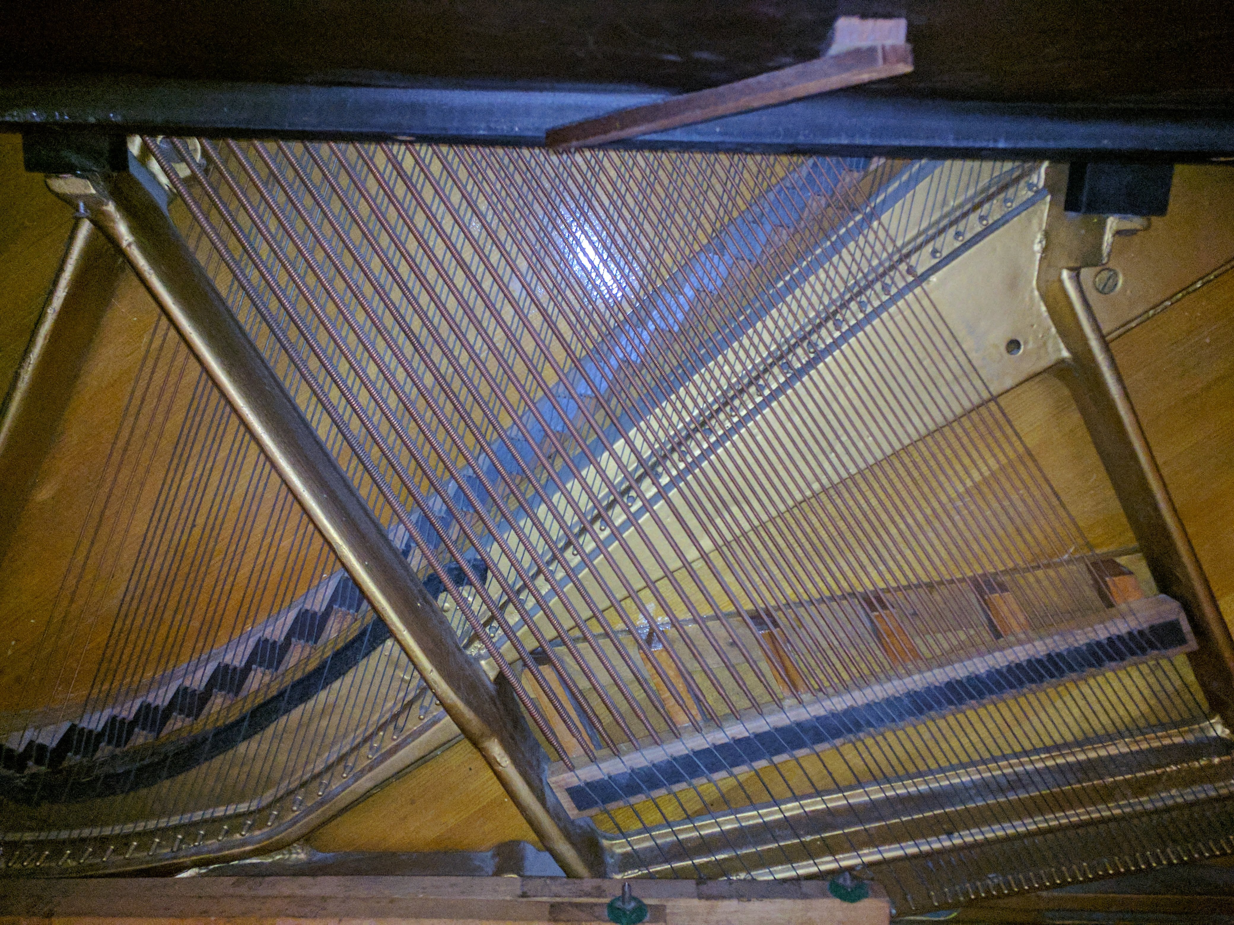 Close up of trap work of Marshall and Rose Piano